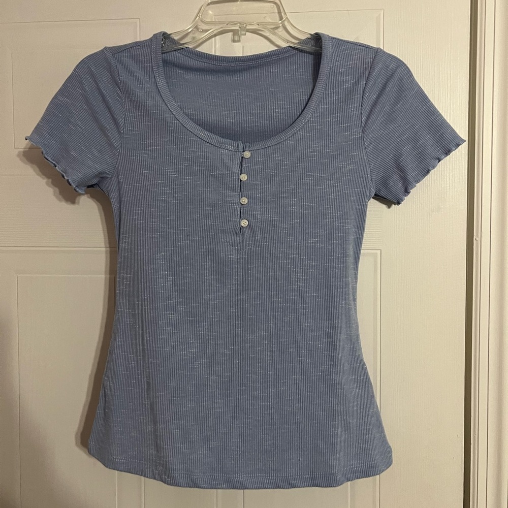 a cut, form fitting, baby blue shirt